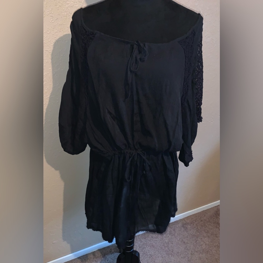 Black swim cover up with lace detail.